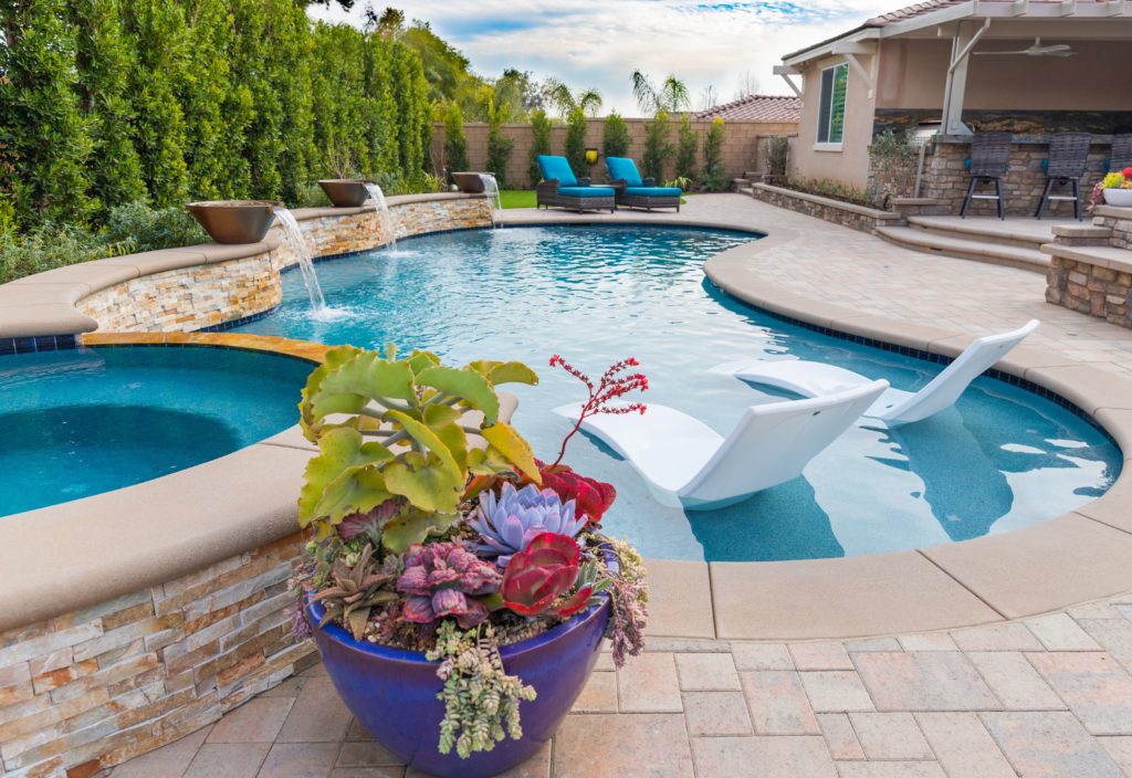 Swimming pool with some fountains and a flower 