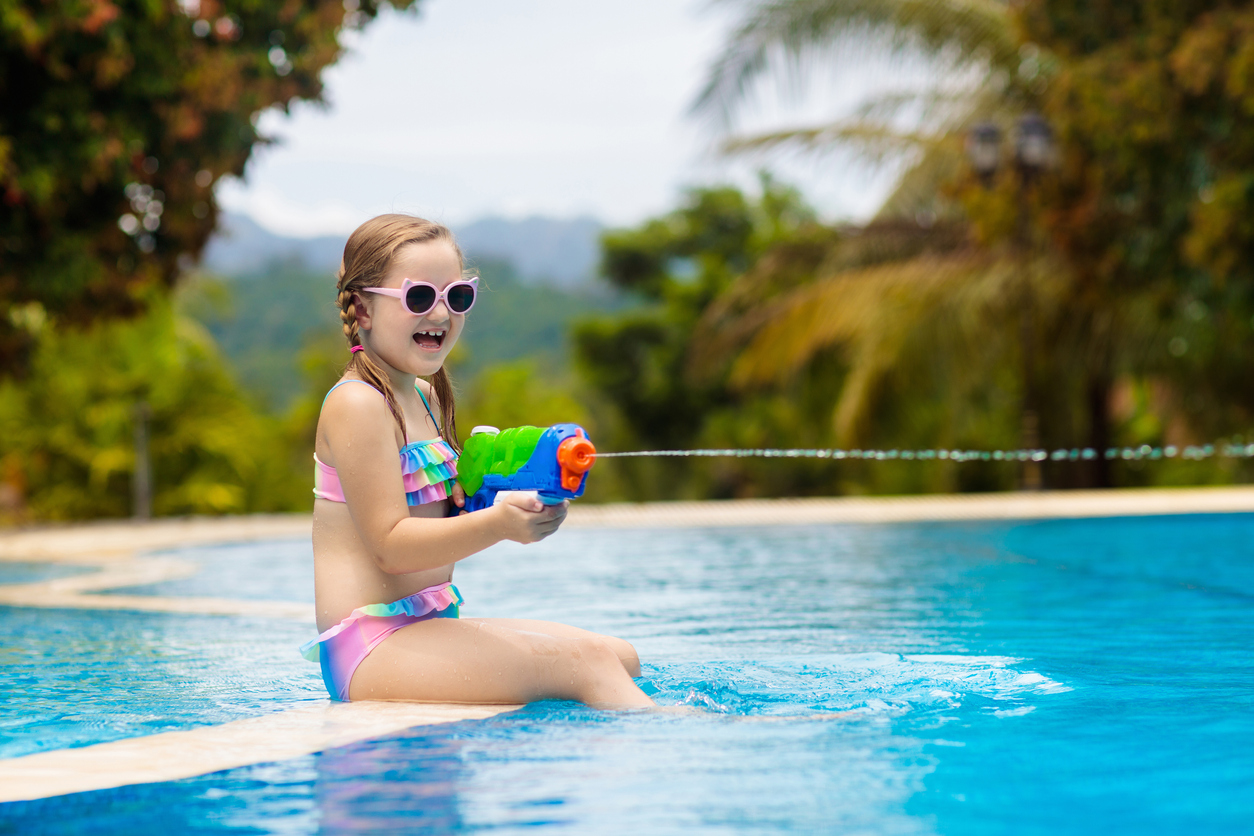 A little girl having fun in the swimming pool.