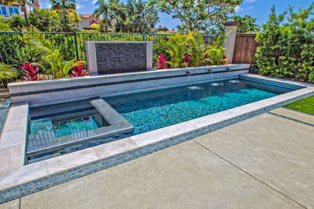 Small, long rectangular pool with spa