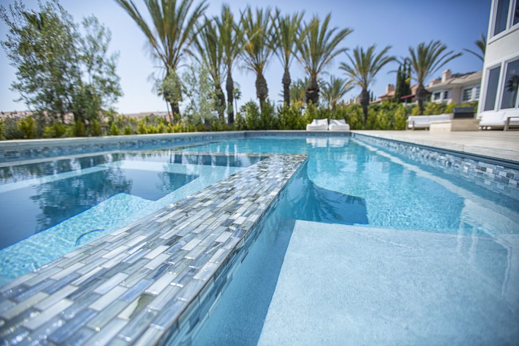 Clear water in the pool with tropical landscaping